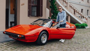 A red sports car parked on a cobblestone street in front of a building with a staircase and a Christmas tree. - MOSTEIRO Hotel de Charme (Garibaldi)