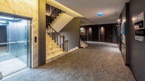A modern hotel lobby with marble walls, a carpeted floor, and a staircase. - Ezkar Bathonea Art İstanbul Hotel (Istanbul)