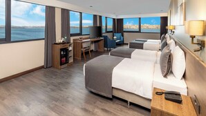 A hotel room with a large window, a desk with a TV, two beds, and a bedside phone. - Ezkar Bathonea Art İstanbul Hotel (Istanbul)