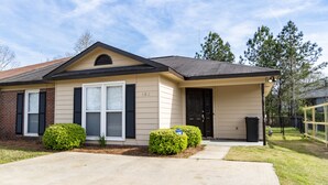 A single-story house with a beige exterior, black shutters, and a dark roof. - Welcome!  The Darby House is named for Colonel William O Darby (Columbus)
