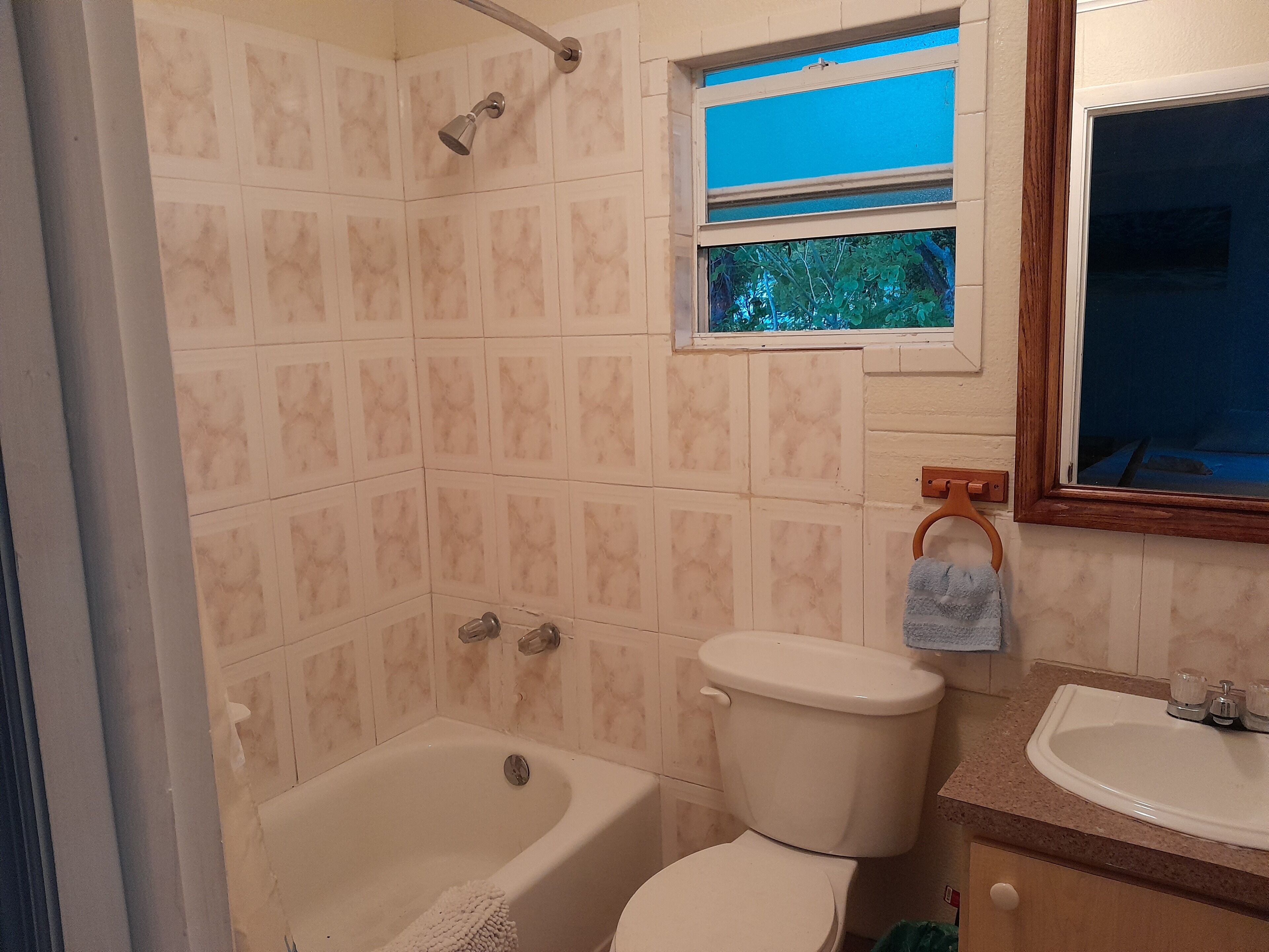 A bathroom with a bathtub, toilet, and sink.