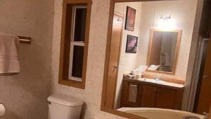 A bathroom with a toilet, a sink, and a large bathtub. - 4-bedroom farm stay 20 minutes from Cooperstown All Star Village Fields (Morris)