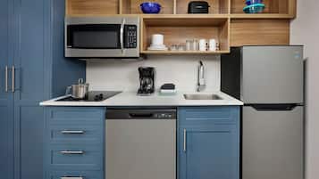 Una cocina moderna equipada con microondas, cafetera y lavavajillas.