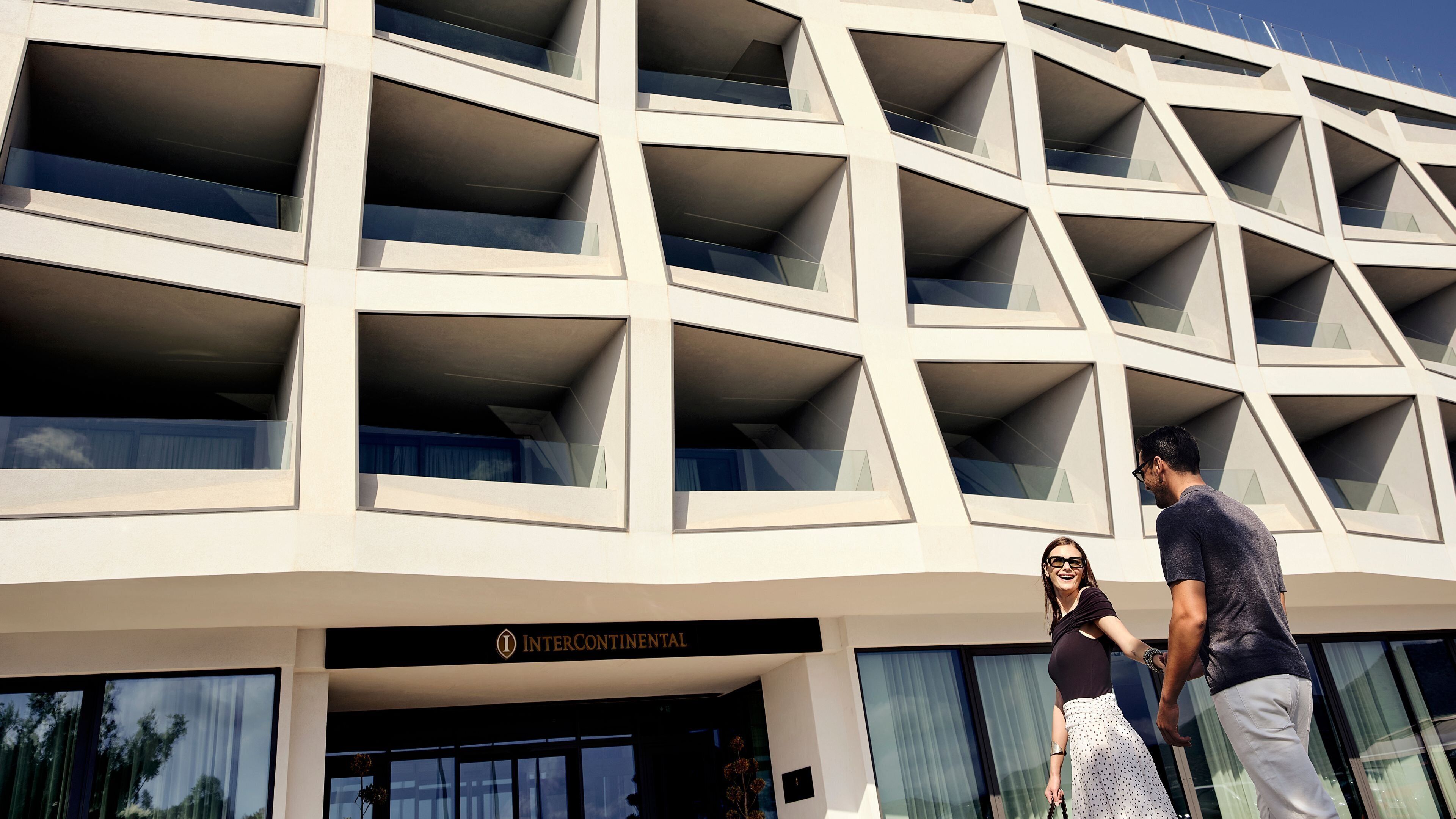 A modern building with a geometric facade and a sign reading 'INTERCONTINENTAL'.