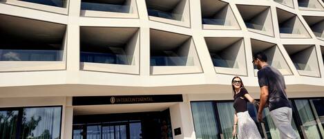 A modern building with a geometric facade and a sign reading 'INTERCONTINENTAL'.