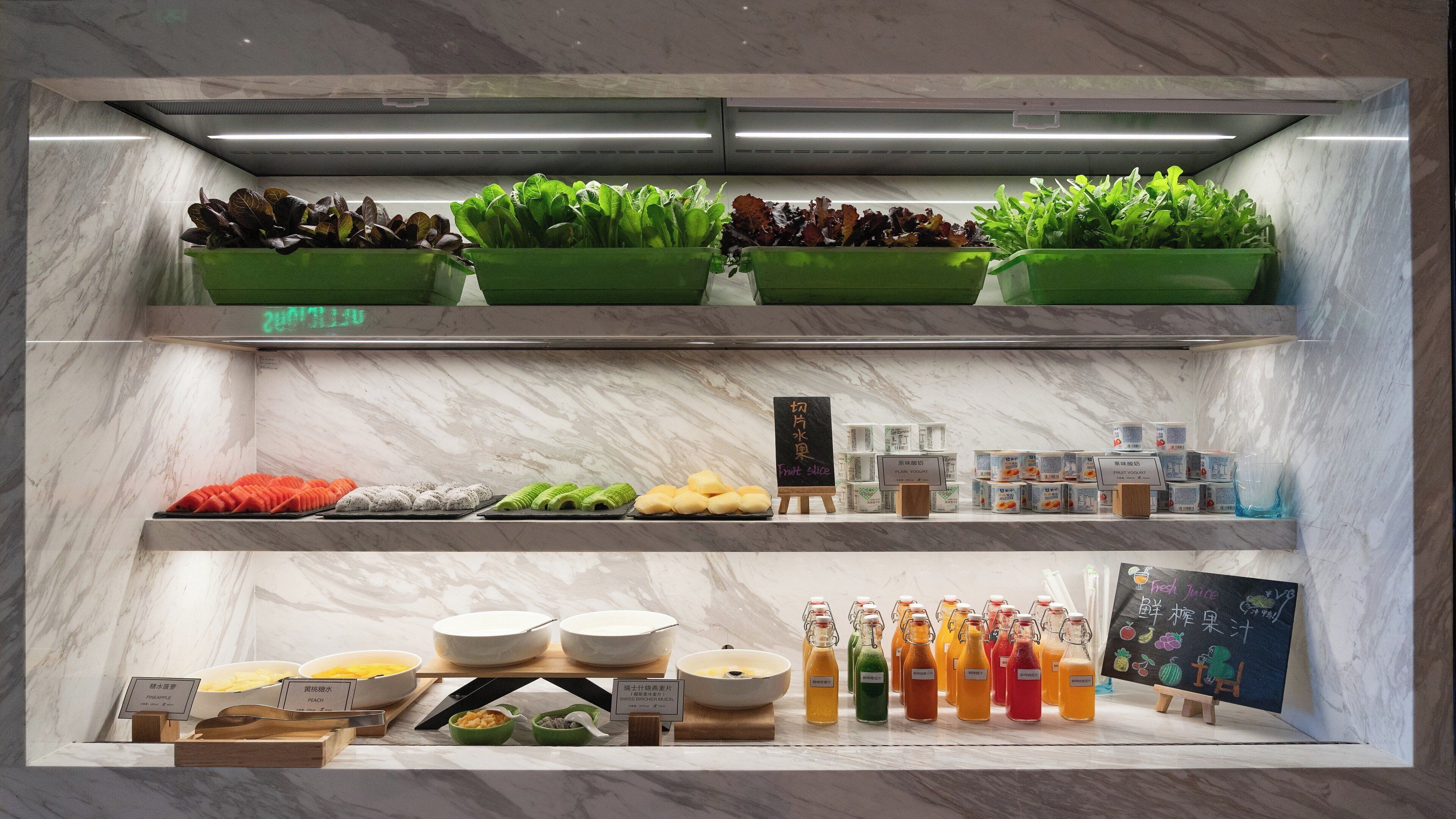A food display with various fruits, vegetables, and beverages.