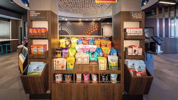 A snack display in a 24/7 market area with various packaged snacks and beverages.