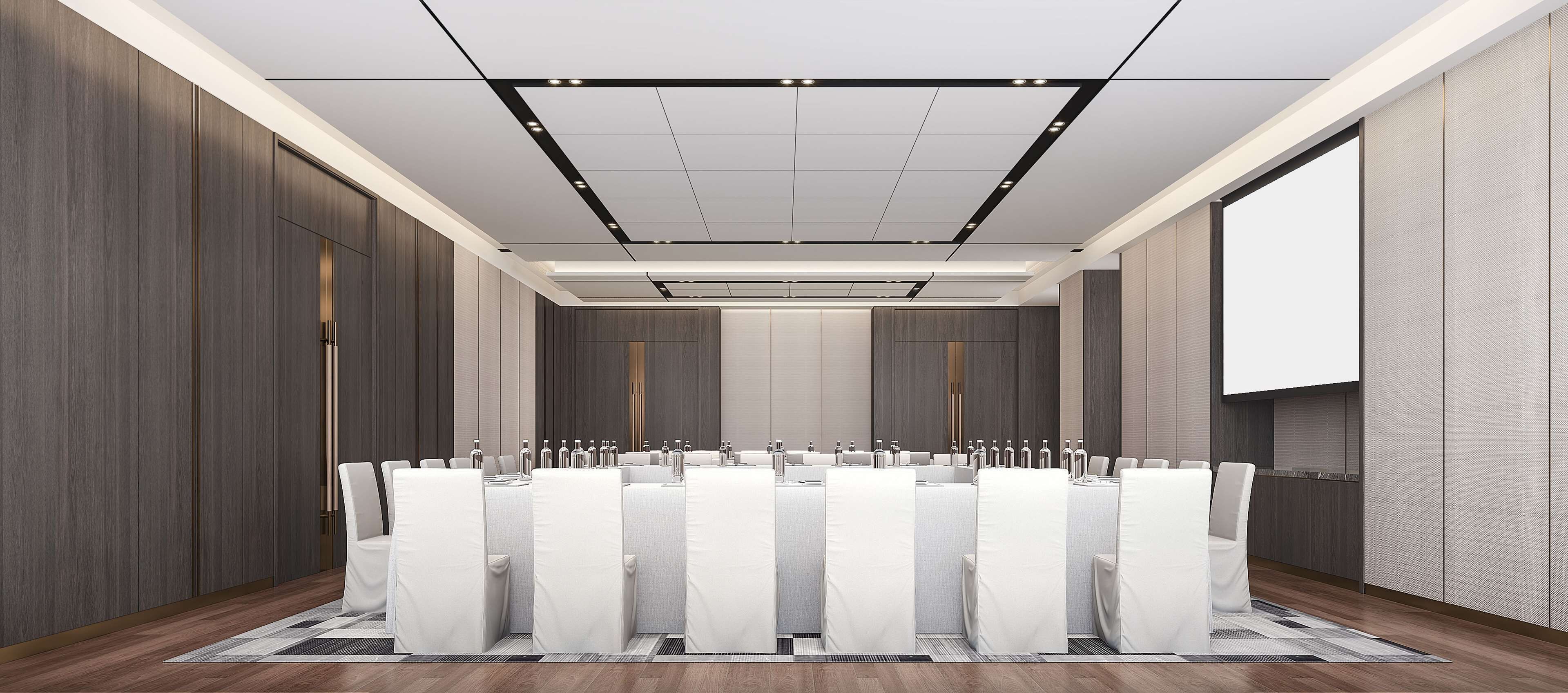 A conference room with a long table, chairs, and a projector screen.