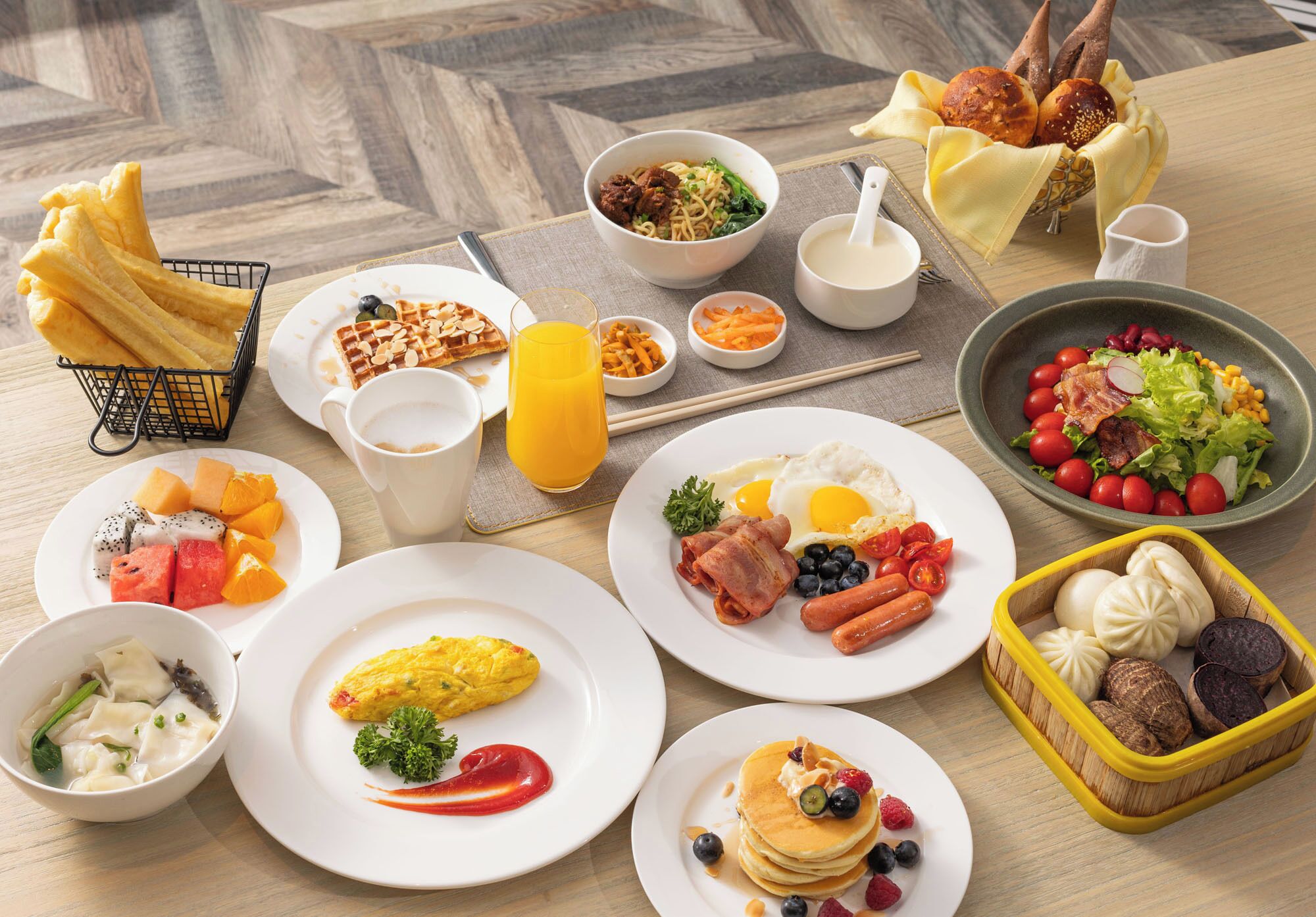 A breakfast buffet with various dishes including eggs, pancakes, and a salad.