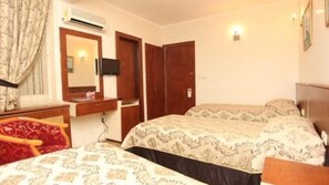 A bedroom with two beds, a mirror, a desk, and a wardrobe. - TURVAN OLD CITY  (Istanbul)