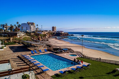 Bright dog-friendly villa with beach views, private patio, outdoor pool, kitchen