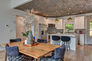 Enjoy cooking in this well-equipped kitchen with a central island, sink, and microwave, and dine in the adjacent seating area.