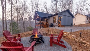 A cabin with a fire pit and red Adirondack chairs in front. - River View Getaway by 2DC (Gilmer County)
