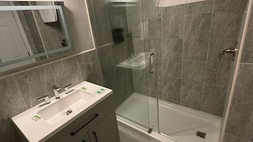Habitación Deluxe | Baño | Ducha y bañera combinadas y toallas