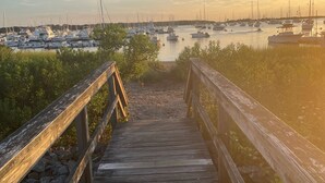A wooden pier leading to a marina with boats and calm water. - Cape Cod Retreat - Sleeps 6 - A/C & Outdoor Shower (Falmouth)
