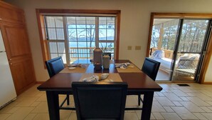 Comedor con mesa, sillas y vistas al exterior.