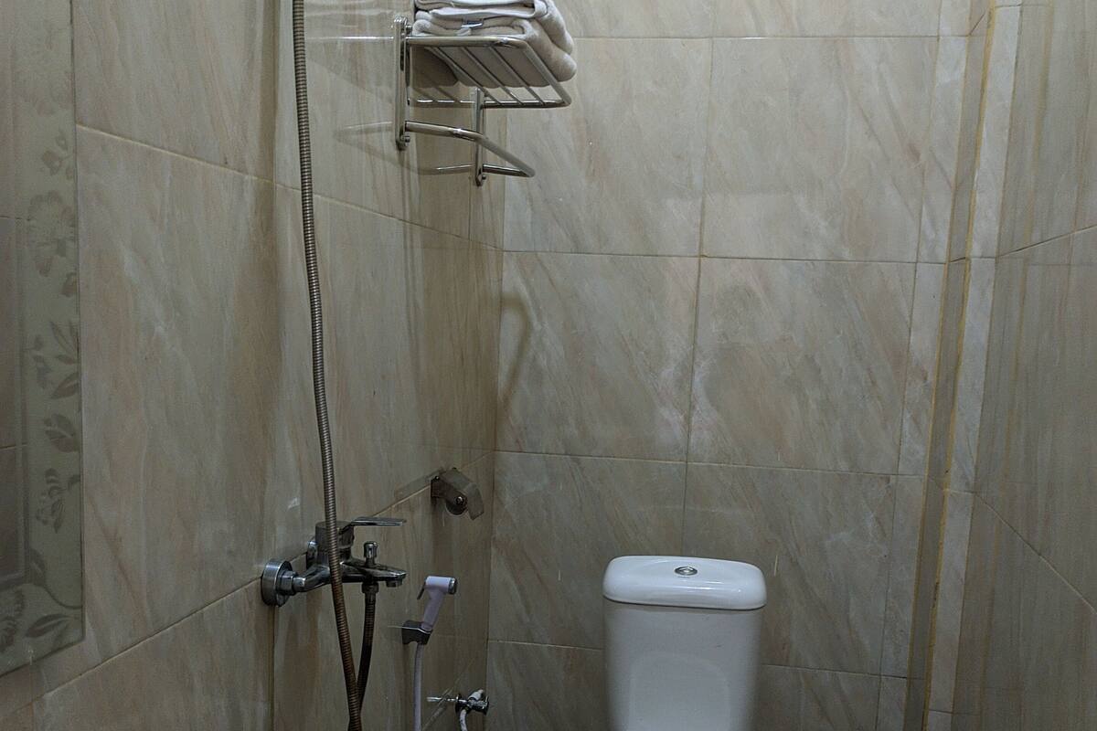 A bathroom with a shower, toilet, and sink.