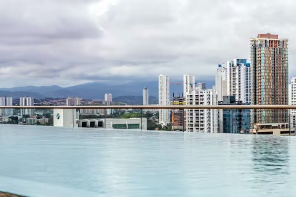 A cityscape with high-rise buildings and a bridge over a body of water.