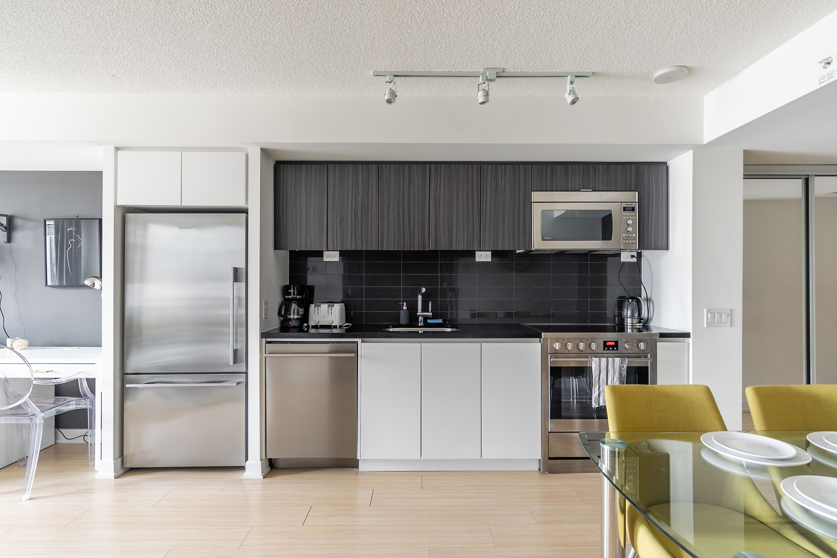 A modern kitchen with stainless steel appliances, a microwave, and a dishwasher.