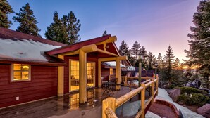 A wooden lodge with a covered porch and a stone pathway leading to the entrance. - Luxe141 Spacious Luxury  Log Cabin (Glenbrook)