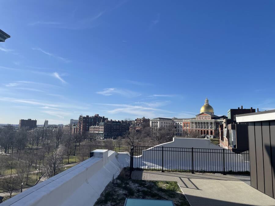A view of a cityscape with a prominent building featuring a golden dome.