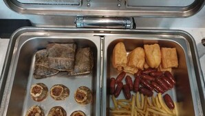 A buffet with various dishes including meat rolls, dumplings, fried items, sausages, and fries. - Yizhi Hotel Panyu Plaza Shiqiao Subway   (Guangzhou)