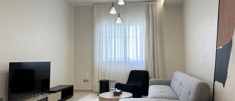 Design Apartment, 3 Bedrooms | Living area | Flat-screen TV