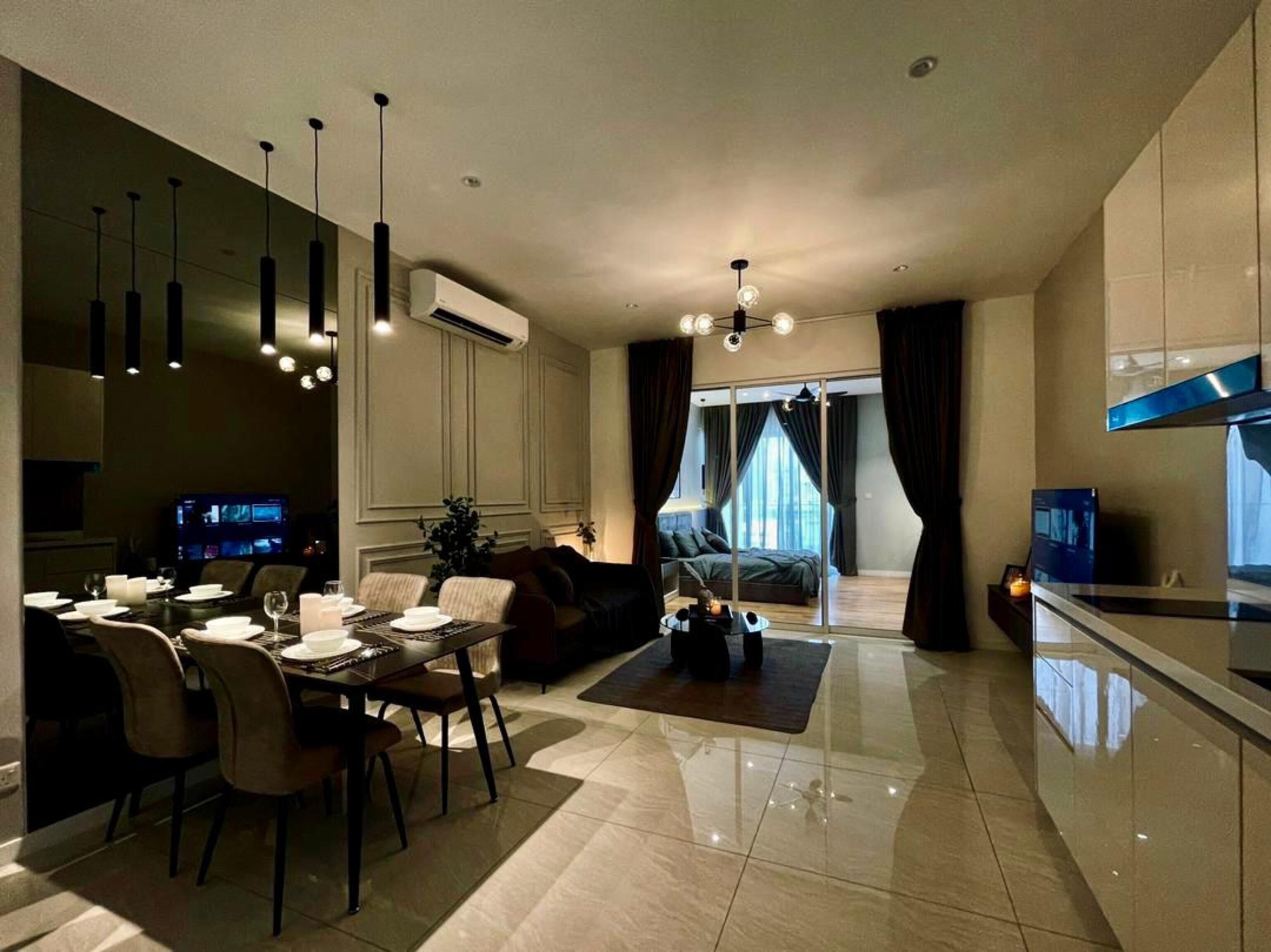 A modern living room with a dining area, a sofa, and a TV.