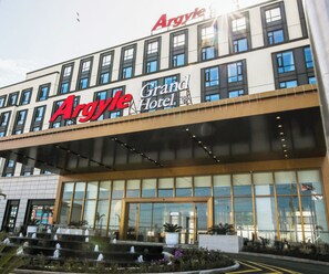 A hotel with a prominent 'Argyle' sign and 'Grand Hotel' branding.