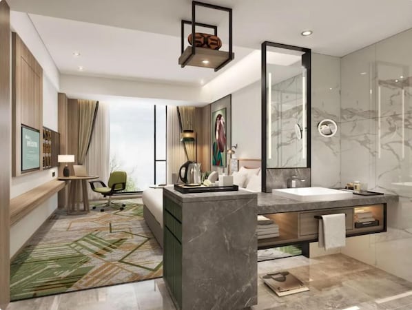 A modern hotel room with a large bed, a sitting area with a desk and chair, a large mirror, a bathroom with a marble sink and shower, and a green patterned rug. - Argyle Grand Hotel (Syokimau)