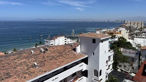 A coastal cityscape with buildings, a marina, and a clear blue sky. - Vidalia 3 - New Condo with Gym and Rooftop Terrace with Jacuzzi (Puerto Vallarta)
