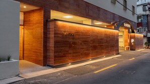 A modern building with a prominent 'AVENUE' sign above the entrance. - H Avenue Munhyeon (Busan)