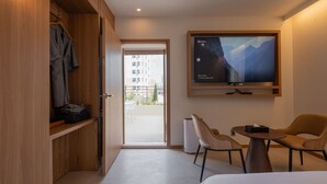 A modern hotel room with a bed, a desk with two chairs, a TV mounted on the wall, and a wardrobe. - H Avenue Munhyeon (Busan)