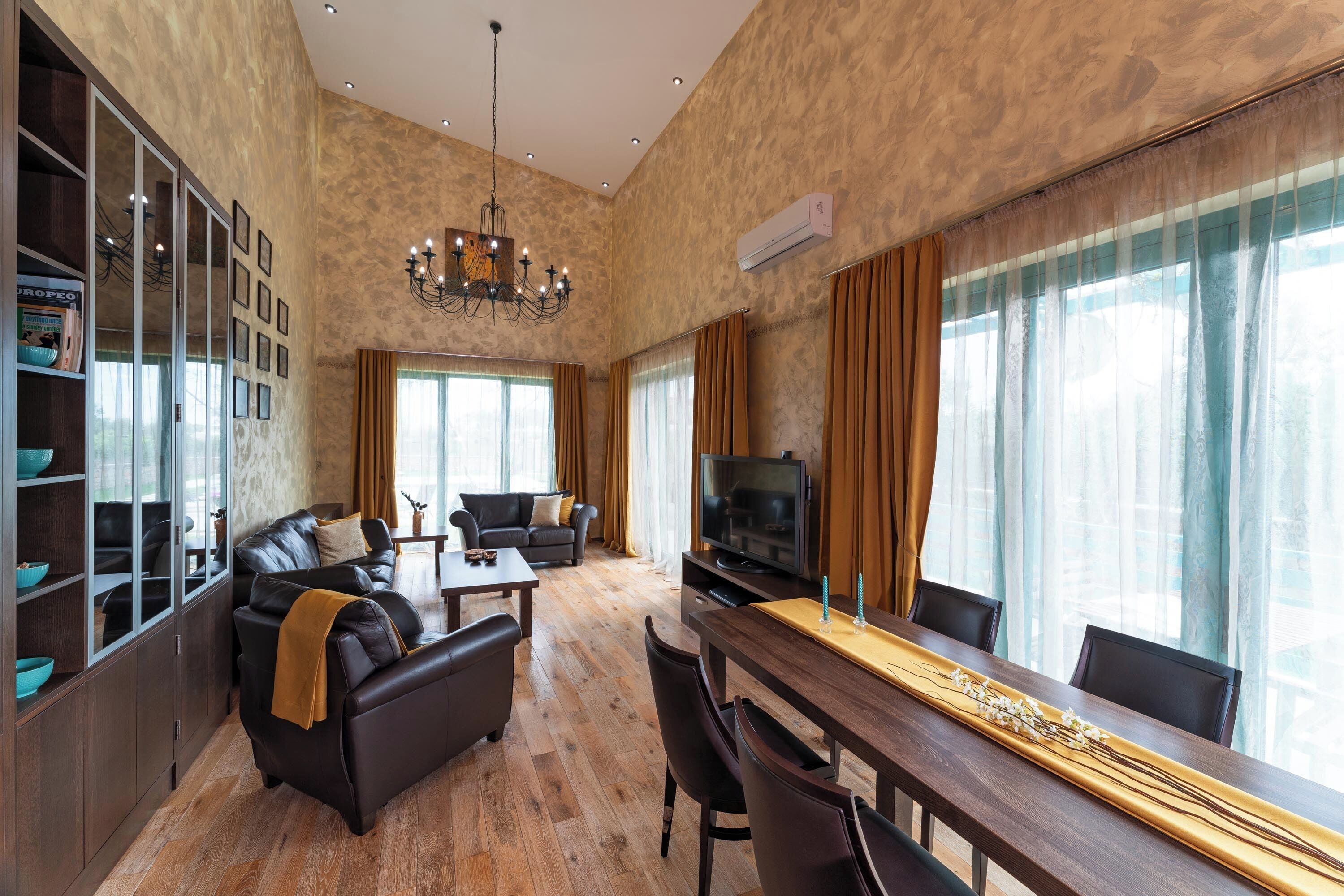 Un amplio espacio de sala con un sofá, una mesa de comedor y un televisor.