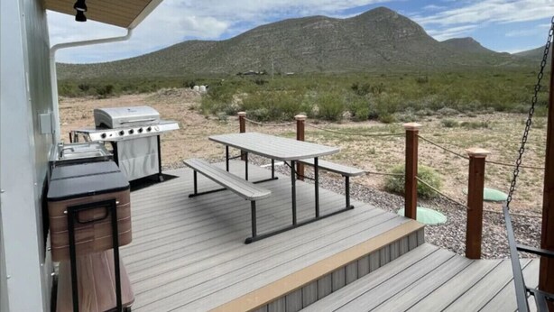 An outdoor deck with picnic tables and a barbecue grill. - Star Gazer  Hideaway (Bisbee)