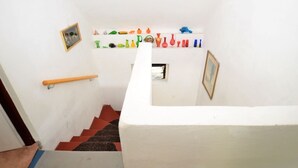 A staircase with a white wall, a handrail, and a series of colorful vases on the landing. - Idyllic Villa with Private Pool in Trebusin Czech Republic (Dolní Týnec)