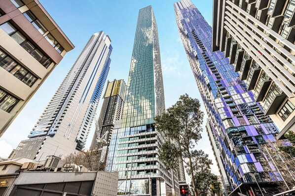 A cluster of high-rise buildings with modern architecture, including glass facades and a mix of vertical and horizontal lines.