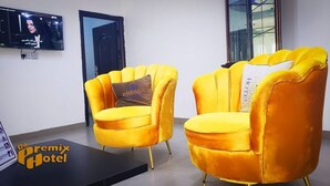 Two yellow armchairs with gold legs in a hotel room. - De Primtex HOtel Portharcourt (Port Harcourt)