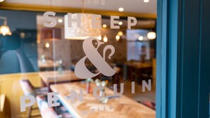 A window with the text "The Sleep & Penguin Wells" indicating a hotel or inn.