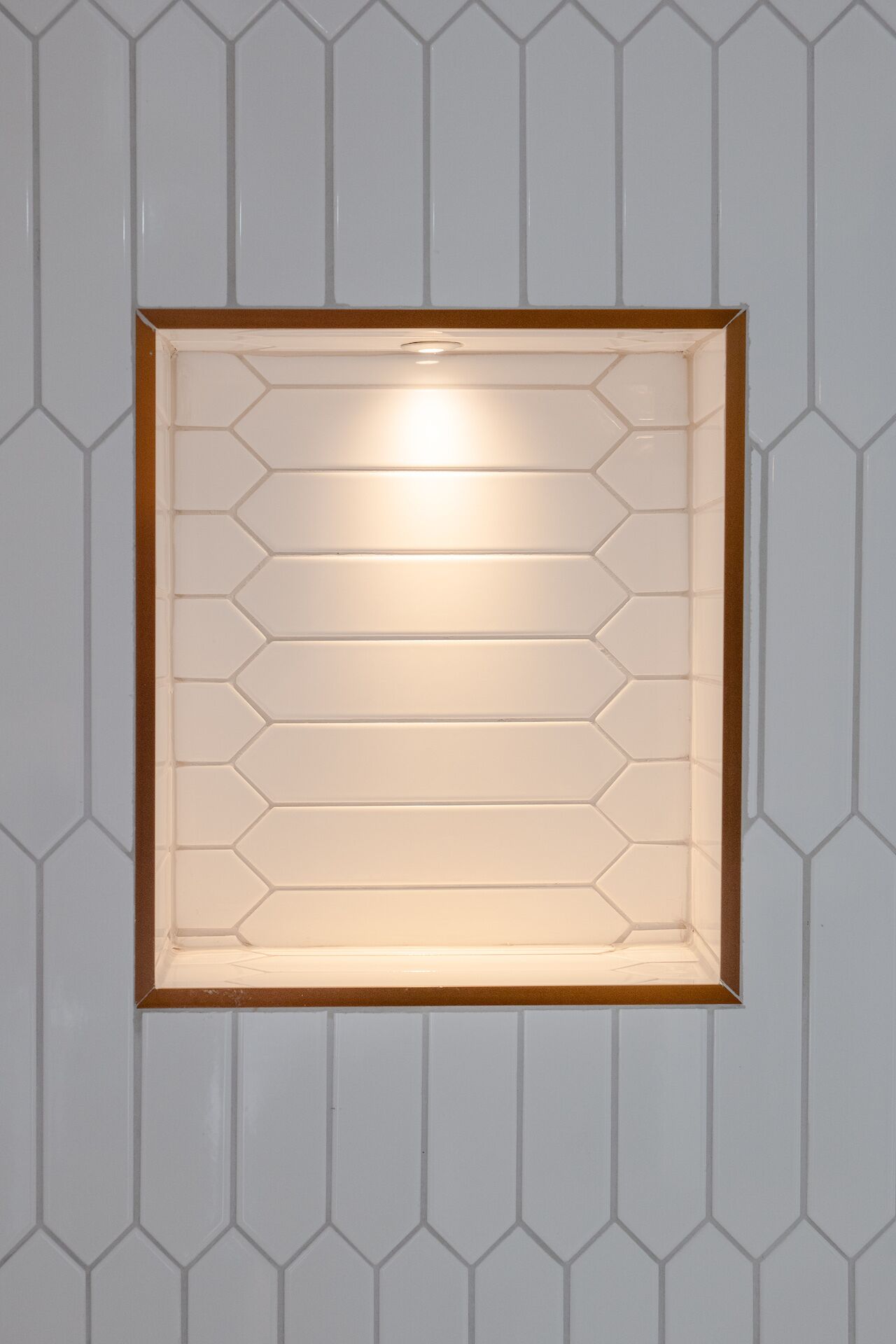 Eine rahmenartige Leuchte mit sechseckigem Muster an einer Wand mit ähnlichem Design.