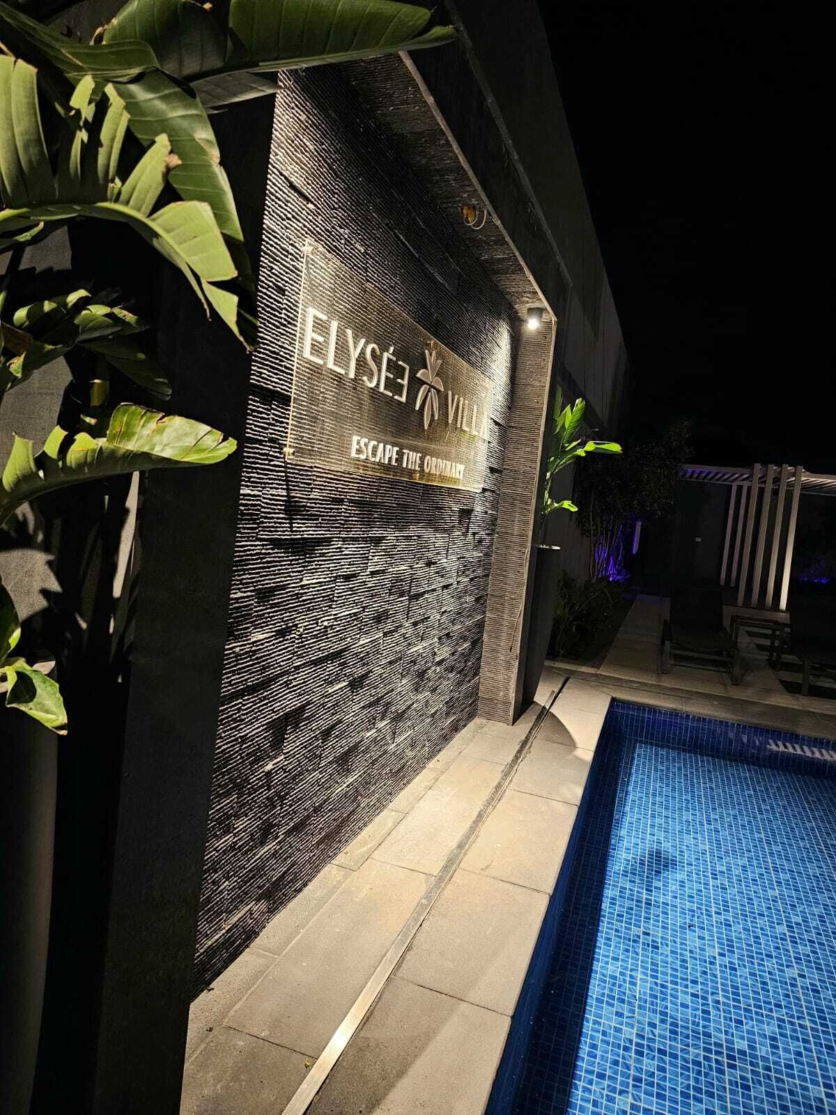 Una entrada de hotel moderna con zona de piscina.
