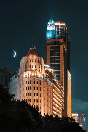 A historic building with a prominent clock tower and a modern skyscraper adjacent to it. - Borrman Hotel Guangzhou Beijing Road Pedestrian Street Donghu Metro (Guangzhou)