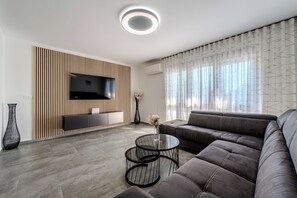 Design Apartment | Living area | 100-cm flat-screen TV with satellite channels - Apartments Royal (Vir)