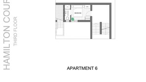 Plan d’étage de l’appartement 6 du Hamilton Court, mettant en évidence la chambre, la salle de bain et l’espace café.