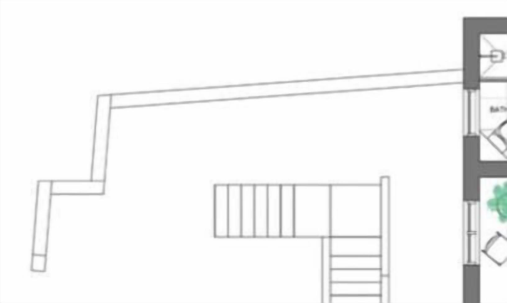 A floor plan with a staircase leading to a landing, a bathroom, and a seating area.