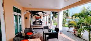 Relax in a serene outdoor space with a seating area and views of lush greenery.