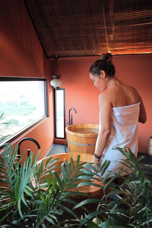 A spa room with a wooden tub, a window, and indoor plants. - 9 Inn - Staycation in Am Am Dalat (Xuan Huong - Da Lat)
