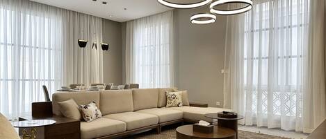 Design Apartment, 2 Bedrooms | Living area | 55-inch Smart TV with cable channels