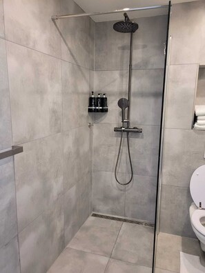 Shower, towels, soap, toilet paper