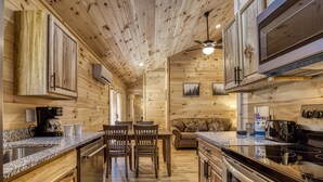 Un intérieur en bois comprenant une cuisine, un coin repas et un espace de vie.